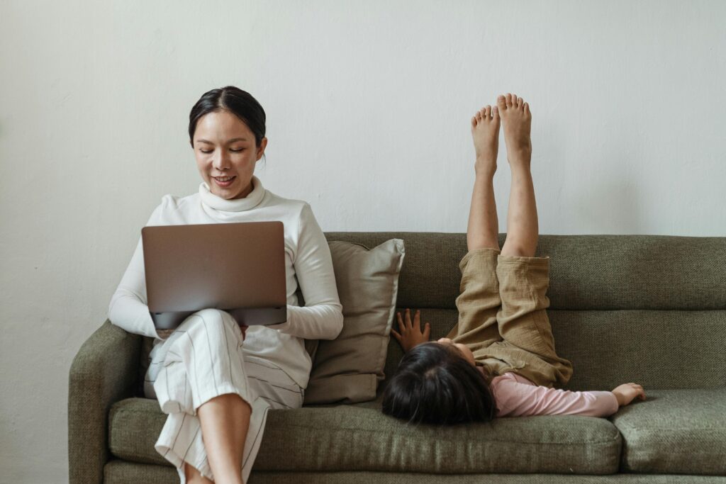 A thoughtful mom in The Colony, TX, smiling with her child after researching local options and choosing Elate Orthodontics for braces and Tribute Family Dentistry for family dental care